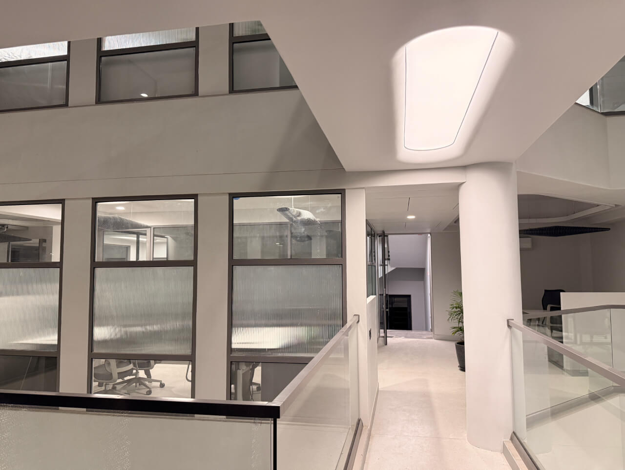 Detailed view of a translucent stretch ceiling by Newmat, highlighting the shadow-free diffusion and high-quality finish for commercial spaces in Gujarat.