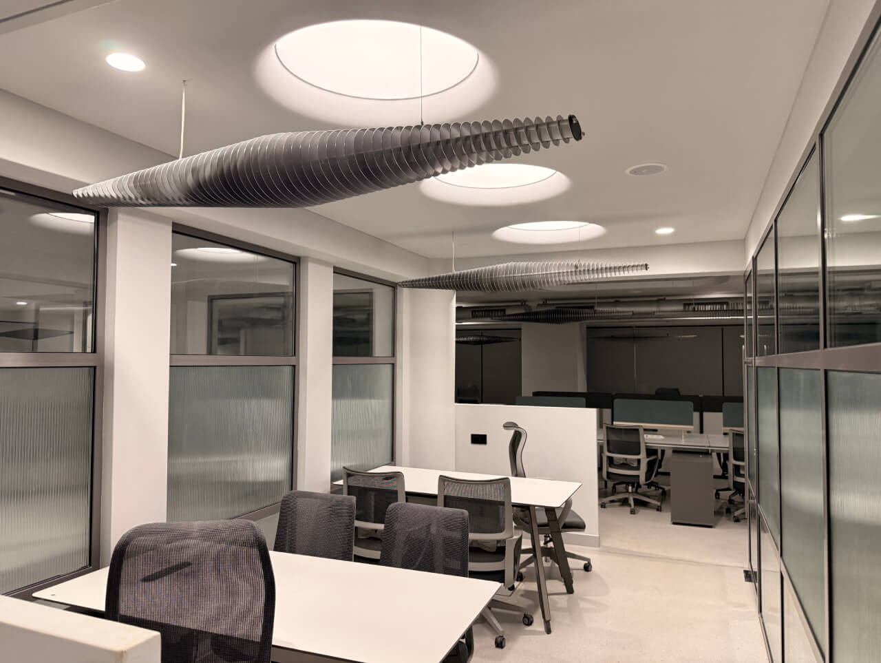 Large-scale office stretch ceiling installation at Cosmos Impex HO, Vadodara, showcasing uniform lux levels and arch